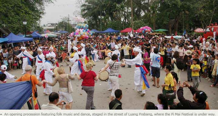 An opening procession featuring folk music and dance, staged in the street of Luang Prabang, where the Pi Mai Festival is under way.