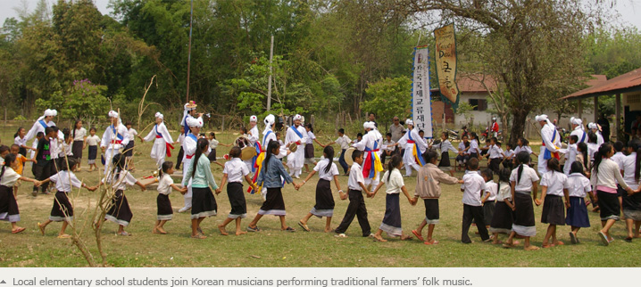 Local elementary school students join Korean musicians performing traditional farmers’ folk music.